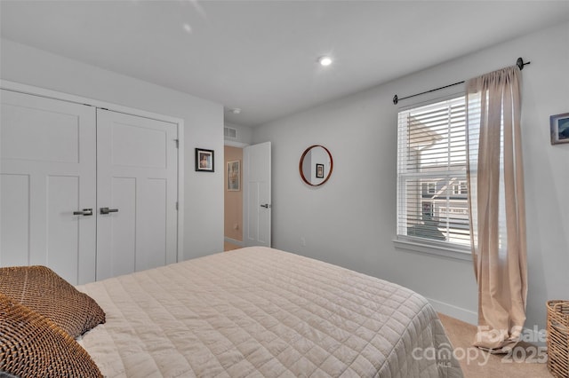 bedroom featuring baseboards, carpet, visible vents, and a closet