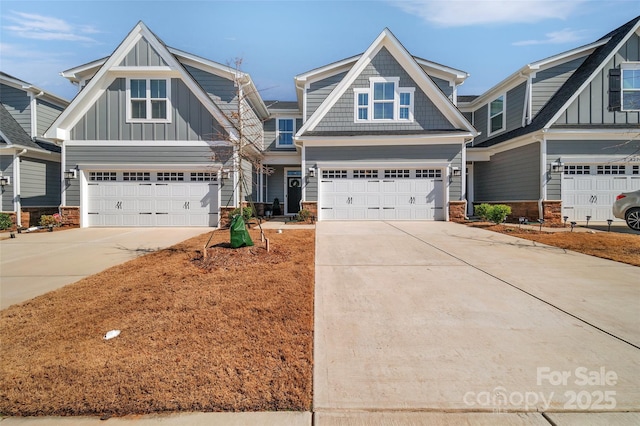 craftsman house with an attached garage, board and batten siding, and concrete driveway