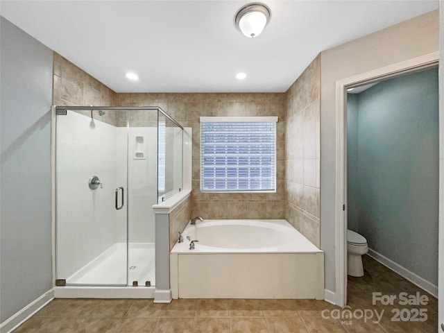 bathroom with baseboards, toilet, tile patterned floors, a shower stall, and a bath