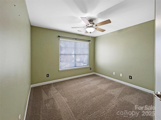 carpeted spare room with ceiling fan, visible vents, and baseboards