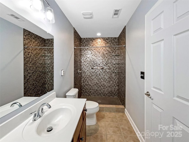 bathroom with visible vents, toilet, a tile shower, vanity, and tile patterned floors