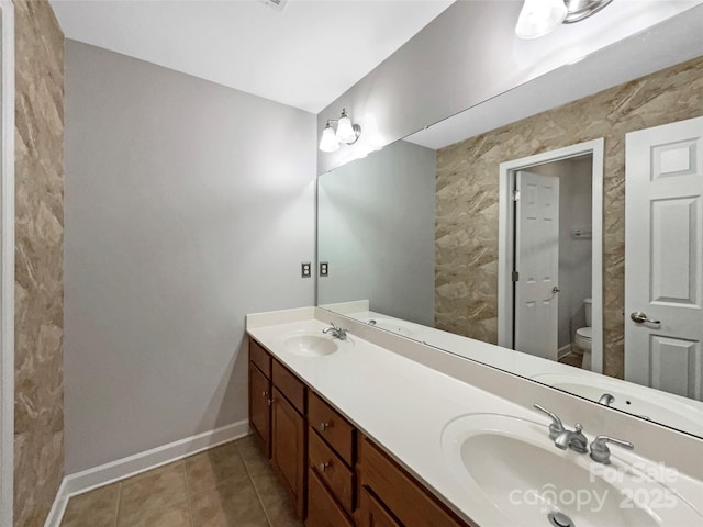 full bathroom with tile patterned flooring, baseboards, a sink, and toilet