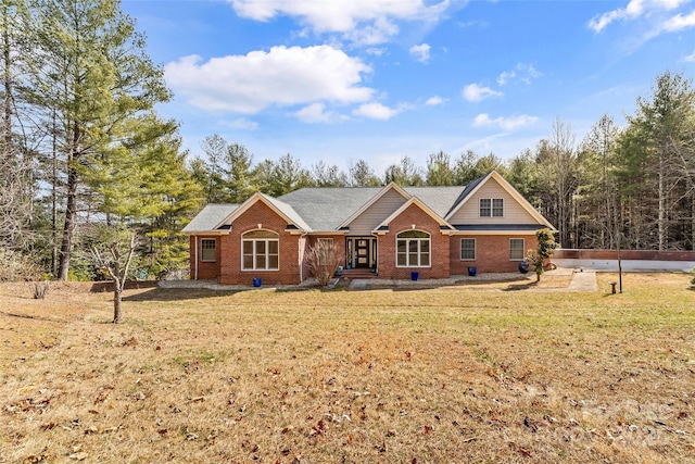 view of front of property with a front lawn and brick siding