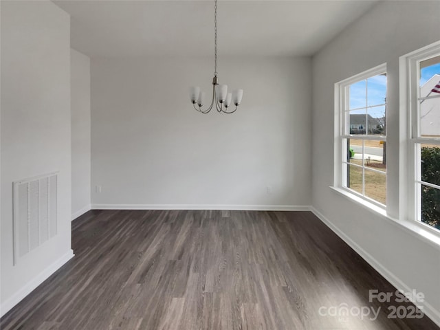 unfurnished dining area with a chandelier, dark wood-style flooring, visible vents, and baseboards