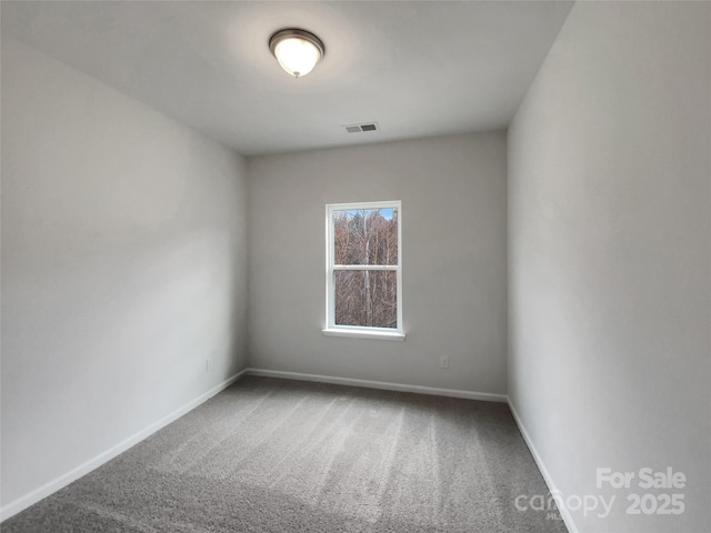 carpeted empty room with visible vents and baseboards