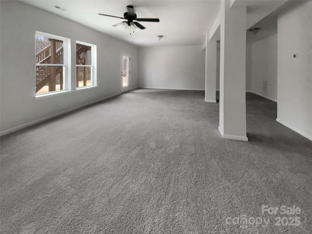 unfurnished living room with carpet floors, baseboards, visible vents, and a ceiling fan