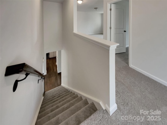 staircase with carpet floors and baseboards