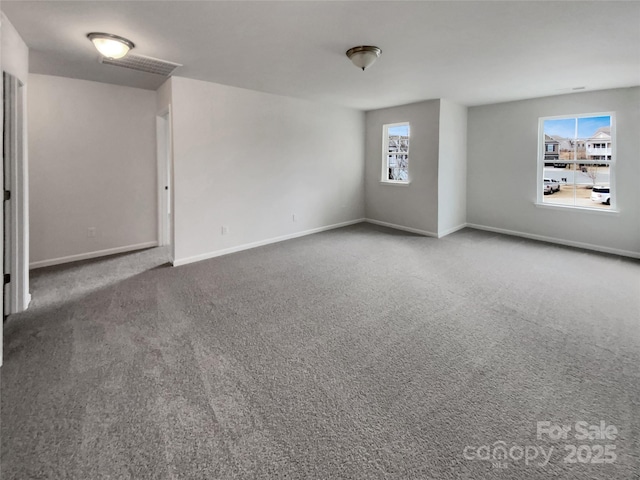 carpeted spare room with baseboards