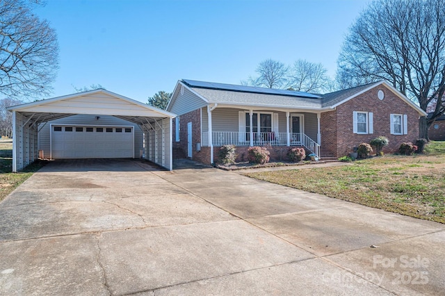 ranch-style home featuring a garage, covered porch, and brick siding