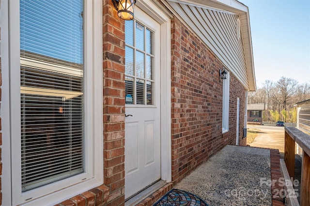 property entrance with brick siding