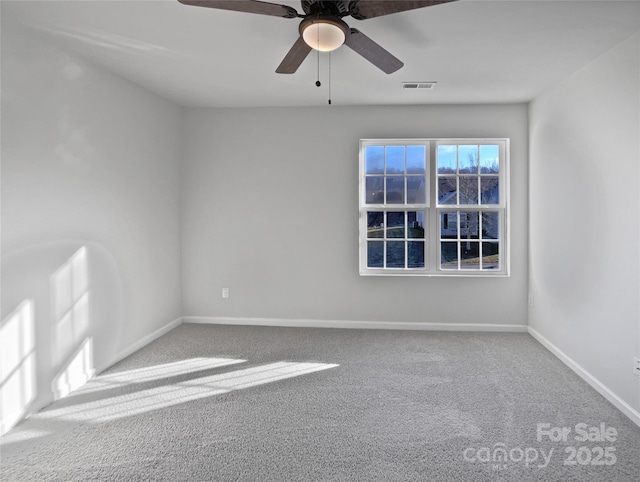 unfurnished room featuring a ceiling fan, carpet, visible vents, and baseboards