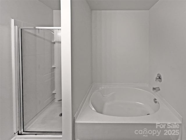 full bath featuring a garden tub and a shower stall