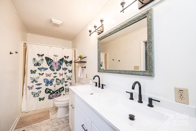 full bathroom featuring marble finish floor, a sink, a textured ceiling, and double vanity