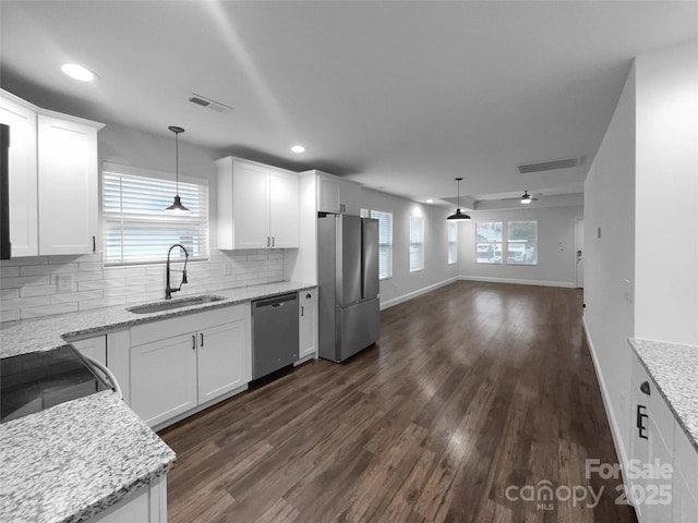 kitchen with a sink, visible vents, white cabinets, a ceiling fan, and appliances with stainless steel finishes