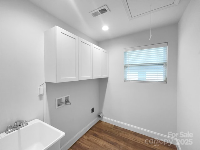 washroom with hookup for a washing machine, a sink, visible vents, cabinet space, and attic access