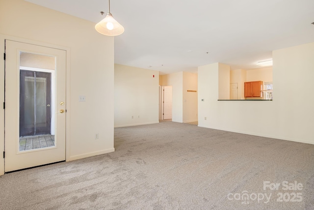 spare room featuring baseboards and carpet flooring