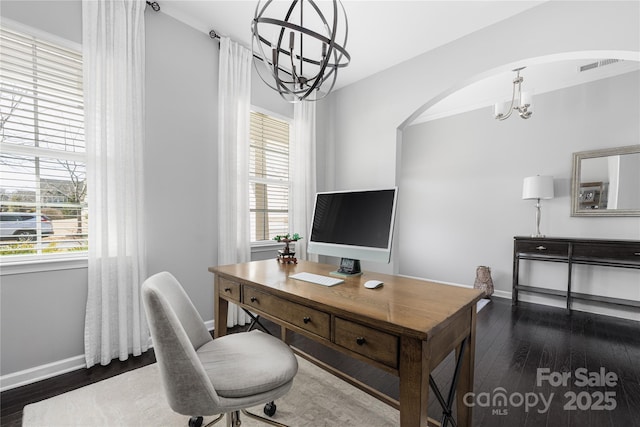 office featuring a chandelier, wood-type flooring, visible vents, and plenty of natural light