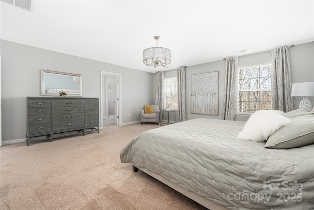 bedroom with baseboards, visible vents, ensuite bathroom, carpet flooring, and a chandelier