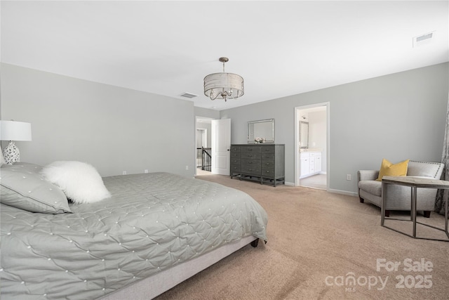 carpeted bedroom with an inviting chandelier, baseboards, and visible vents