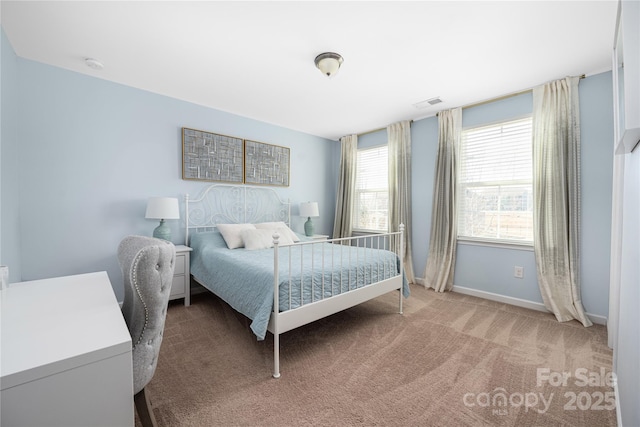 carpeted bedroom with visible vents and baseboards