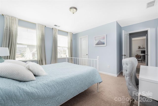 carpeted bedroom featuring visible vents and baseboards