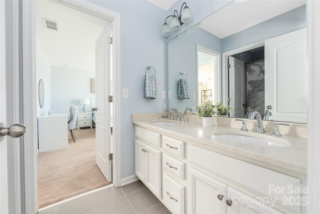 full bath featuring double vanity, visible vents, a sink, and tile patterned floors