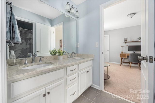 bathroom with double vanity, a sink, and baseboards