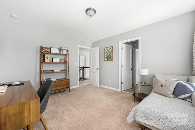 bedroom with baseboards and light colored carpet