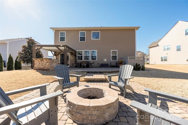 back of property with an outdoor fire pit, a patio area, and a pergola