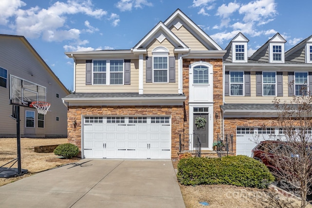 view of front of house featuring driveway, stone siding, and a garage