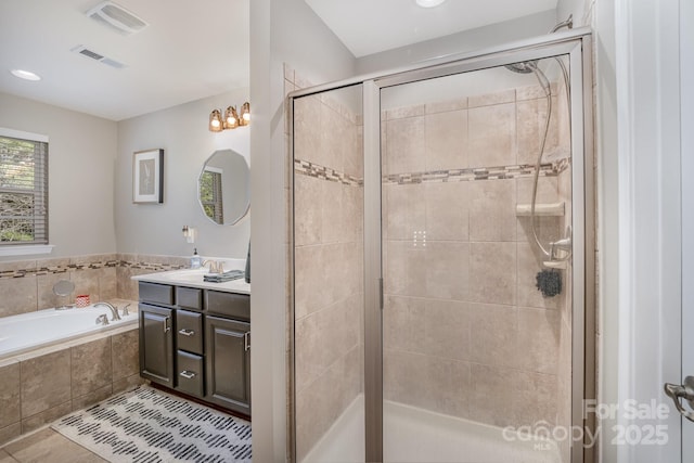 full bathroom featuring visible vents, a shower stall, vanity, and a bath