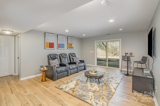 living room featuring recessed lighting, wood finished floors, and baseboards