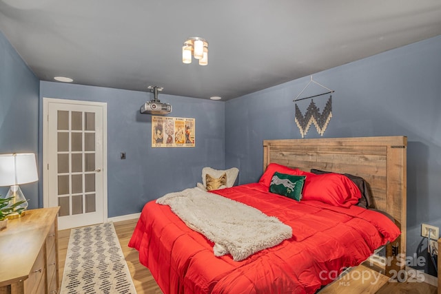 bedroom with wood finished floors and baseboards