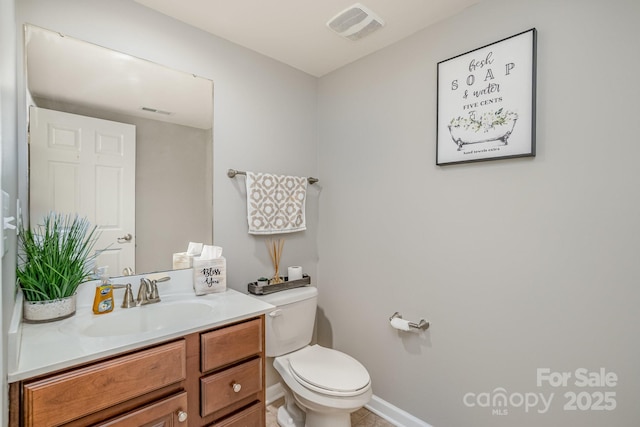 half bath with toilet, baseboards, visible vents, and vanity