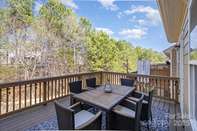 wooden deck featuring outdoor dining space