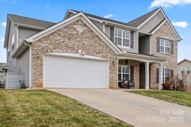 craftsman house with brick siding, driveway, and a front lawn