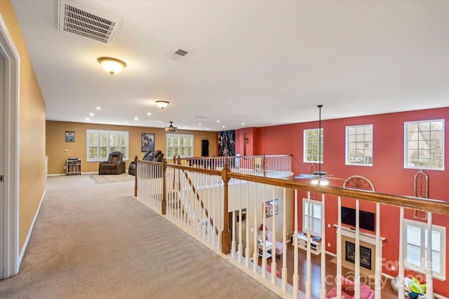 corridor with recessed lighting, visible vents, carpet floors, and baseboards