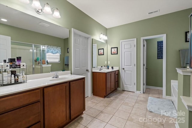 bathroom featuring tile patterned floors, a stall shower, visible vents, and a sink