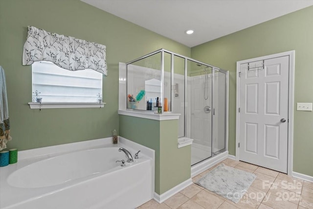 bathroom with tile patterned floors, a stall shower, baseboards, and a garden tub