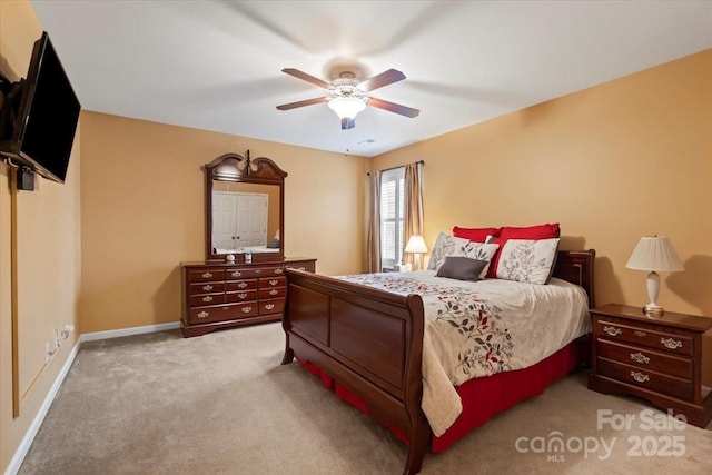 carpeted bedroom with baseboards and ceiling fan