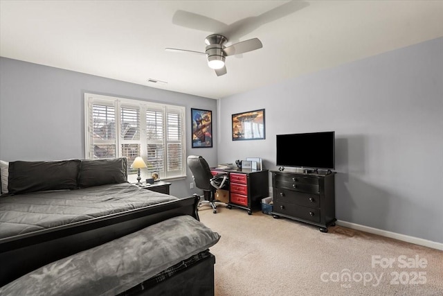 carpeted bedroom with visible vents, baseboards, and ceiling fan