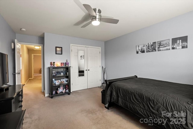 bedroom featuring light carpet, ceiling fan, and a closet