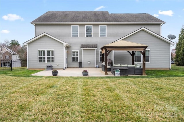 back of house with a gazebo, an outdoor living space, a lawn, and a patio