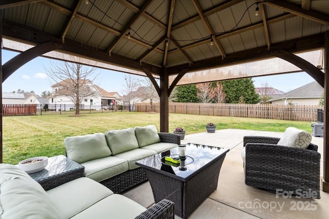 view of patio / terrace featuring a gazebo, an outdoor living space, a residential view, and a fenced backyard