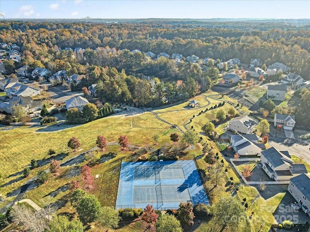 birds eye view of property with a forest view and a residential view