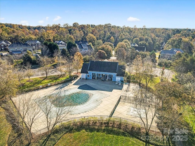 drone / aerial view with a wooded view