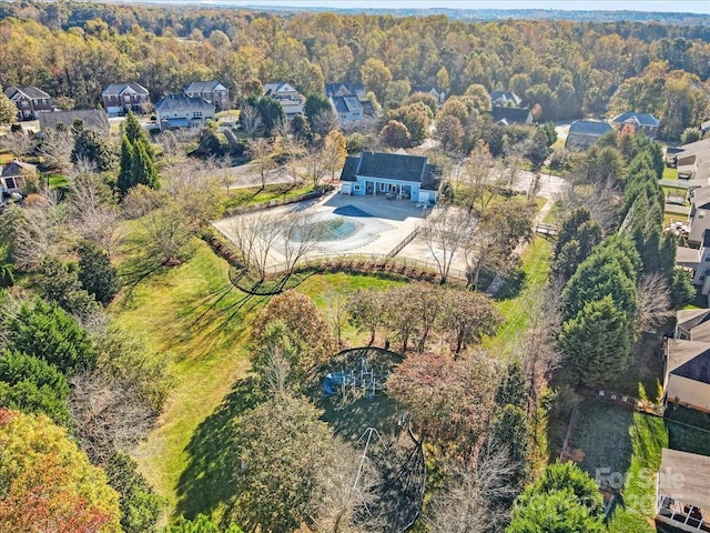 drone / aerial view with a residential view and a view of trees