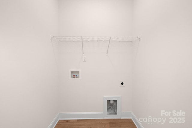 washroom with hookup for an electric dryer, laundry area, washer hookup, wood finished floors, and baseboards