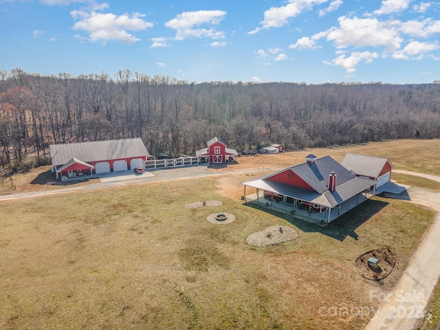 drone / aerial view featuring a wooded view