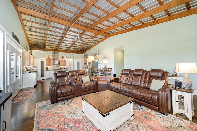 living area featuring high vaulted ceiling, concrete floors, and ceiling fan